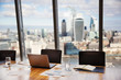 © Robert Daly/Caia Image - Modern highrise business conference room overlooking city