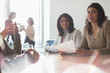 © Tom Merton/Caia Image - Businesswomen listening in sunny conference room meeting