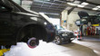 © Tom Merton/Caia Image - Cars in auto repair shop