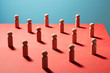 © Andy Roberts/Caia Image - Wooden pawn chess pieces on red surface
