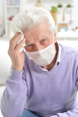 Sticker - Portrait of sad sick senior man with facial mask