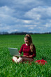 © DSMT - Joyful young girl on the grass with a laptop on her lap. He raised his hands up and laughed. Happiness in the lifestyle of a classical student. Work on the nature. Rest after a good working day.