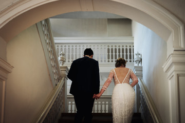 Poster - photo of a bride and a groom going upstairs