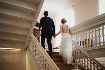 Wall Mural - photo of a bride and a groom going upstairs