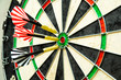 © Dmitry - four darts stuck in the middle of a darts board.