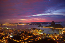 High Angle View Of Illuminated Residential District And Guanabara Bay At Dusk
