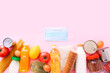 Food supplies for the period of quarantine on pink background. Set of grocery items from canned food, vegetables, pasta, cereal. Food delivery concept. Donation concept. Top view.