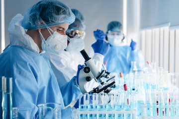 Wall Mural - caucasian biological research scientist and team working together in vaccine development laboratory 