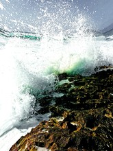 Wave Splashing On Rocky Shore
