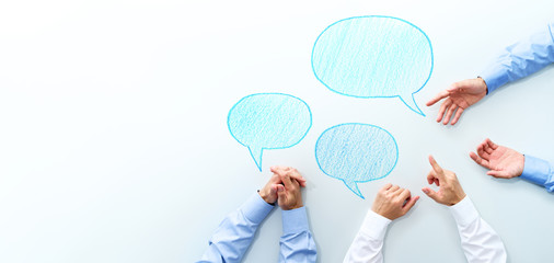 Aufkleber - Top view of business meeting. Three men discussing at white table. Three speech balloon and copy space.