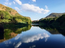 Scenic View Of Hartbeespoort Dam With Clouds Reflection In River