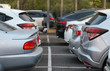 © Amphon - Closeup of back, rear side of soft blue cars parking in the opposite side in outdoor parking area.