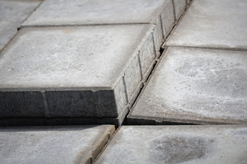 Stack of gray paving slabs. Construction of sidewalks. Building materials for the construction of the sidewalk.