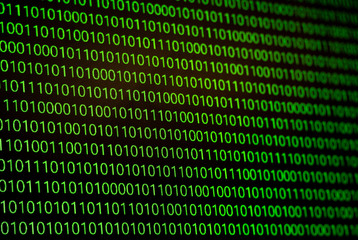 binary numbers, zeros and ones, in green on a black computer monitor