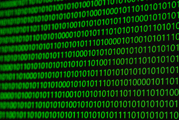 binary numbers, zeros and ones, in green on a black computer monitor