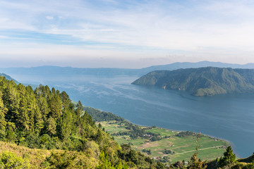 Wall Mural - View from the island of Samosir to Lake Toba, the largest volcanic lake in the world situated in the middle of the northern part of the island of Sumatra in Indonesia