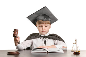 Sticker - Portrait of little judge sitting at table against white background