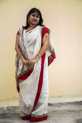 Beautiful South East Asian lady in white and red traditional dress with light background