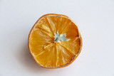 Fototapeta Kuchnia - half old moldy lemon on a white background, unappetizing in appearance, blue mold dangerous