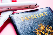 Travel Concept. Model Of Airplane On Pink Background With Passport.