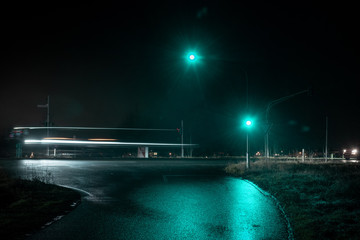 Traffic light showing green light in wet night.