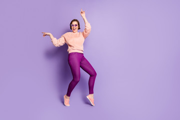 Wall Mural - Full size photo of cheerful funky girl dance moving on disco feel rejoice wear good looking fluffy clothes isolated over violet color background