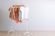 fashion clothes on a rack in a light background indoors. place for text