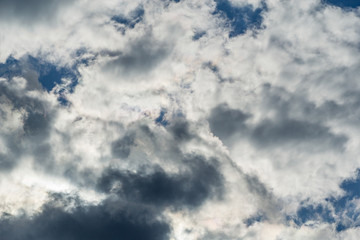 Blue sky with beautiful fluffy white clouds. The mood of happiness, love and delight. Great background for any design. Place for text and any items.