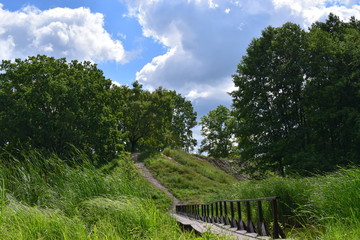 landscape with village bridge, blue sky and clouds