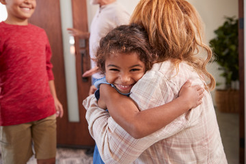 Wall Mural - Grandparents Greeting Grandchildren At Front Door As They Comes To Visit