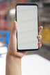 © freeject.net - Woman hand holding black smartphone with blank screen for mock up. Cropped shot view of woman's hands holding a smartphone with blank copy space screen for your text message or information content.