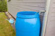 Rain water rainwater harvesting collecting in the garden into a plastic barrel. Ecological system for plants watering
