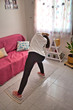 © J.J. Martínez - Young woman wearing black leggins and white t-shirt while doing yoga and meditation at home