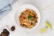Wok noodles with chicken, shrimp and vegetables, seasoned with aromatic Thai sauce. Food delivery.