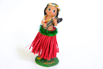 Hula dancer doll (girl) with ukulele on the white background