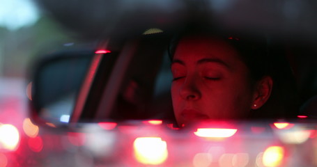 Wall Mural - Female driver stuck in traffic closing and opening eyes seen through rearview. mirror Woman stuck in traffic jam,