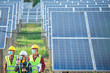 © เลิศลักษณ์ ทิพชัย - A team of engineers and three Asian architects walked to visit the solar panel. Engineering team wearing medical masks to protect the corona virus (Covid-19). Asian engineers look at solar panels.