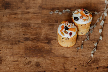 Delicious festive Easter cake near willow, easter celebration concept, flat lay view, festive food on wood backgroun