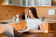 © Andrii - A young girl works at home on a remote site. Distance learning. Stay at home