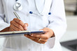 © H_Ko - Female doctor arm hold silver pen filling