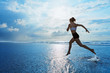 © Tropical studio - Barefoot young girl with slim body running along sea surf by water pool to keep fit and burning fat. Beach background with blue sky. Woman fitness, jogging sports activity on summer family vacation.