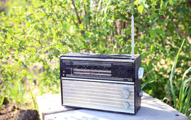 Old radio on wooden background