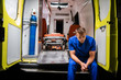 © Anna Kosolapova - Man in a medical uniform sitting in the ambulance car at night