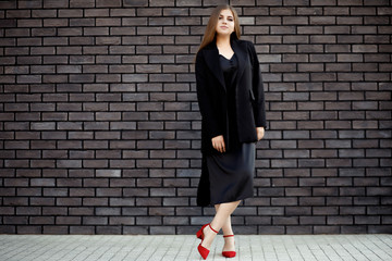 Busines woman in a stylish clothes. Business portrait of a girl. Confident business woman in stylish formal clothes and with a charming smile.