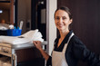 A portrait of a smiling housekeeping lady in a uniform