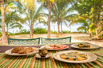 Breakfast on sea beach in Varadero/Cuba. Table setting with food and coffee in restaurant outdoor.