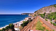 High Angle View Of Railway Tracks Along Calm Blue Sea