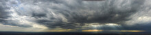 Panorama With A View Of The Rapidly Approaching Thunderstorm, The Sun's Rays Shining Through The Clouds.