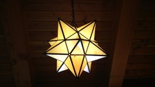 Low Angle View Of Illuminated Star Shape Lantern Hanging From Ceiling