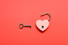 Unlocked Heart Shape Padlock With Key On A Red Background